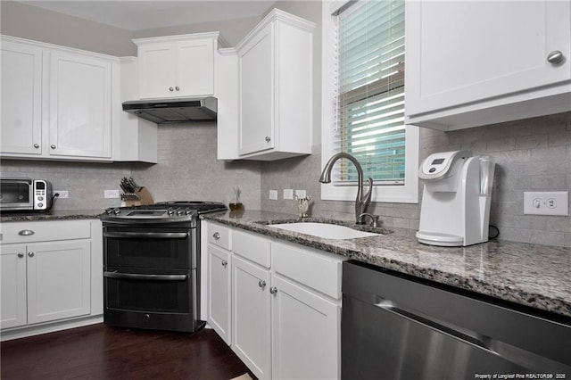 308 Wishaw Ct, Hope Mills, NC 28348 - kitchen with under cabinet range hood, stainless steel appliances, a sink, and dark stone countertops