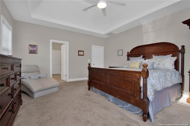 308 Wishaw Ct, Hope Mills, NC 28348 - bedroom with light colored carpet, a ceiling fan, baseboards, a tray ceiling, and visible vents