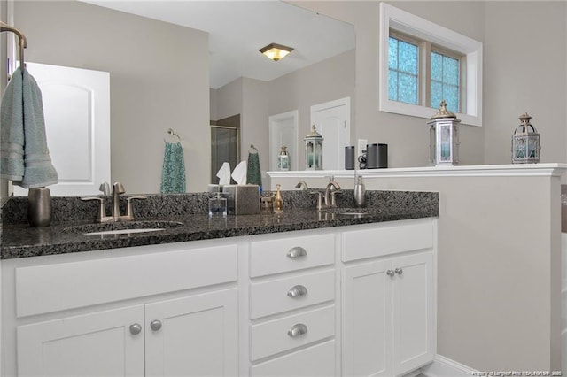 308 Wishaw Ct, Hope Mills, NC 28348 - bathroom featuring double vanity, a shower stall, and a sink