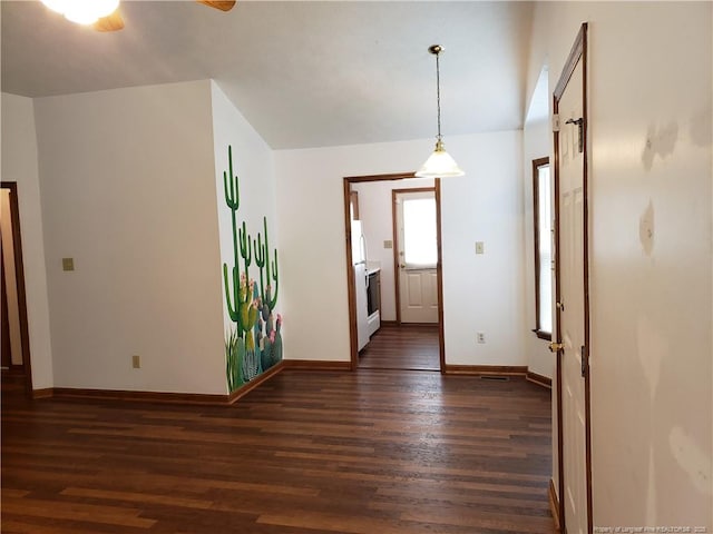 interior space with baseboards and dark wood-style floors