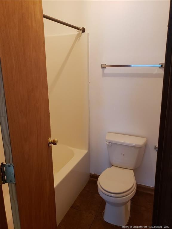 bathroom with toilet, tile patterned floors, and baseboards