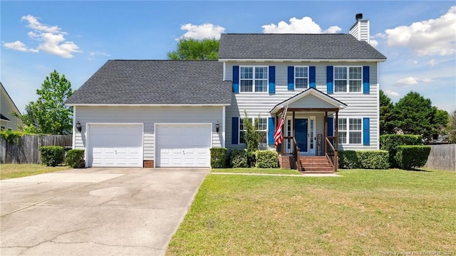 colonial home with a chimney, a front yard, fence, concrete driveway, and an attached garage