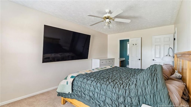 bedroom with baseboards, ceiling fan, a textured ceiling, carpet flooring, and ensuite bath