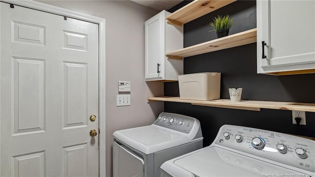 laundry room with washing machine and dryer and cabinet space