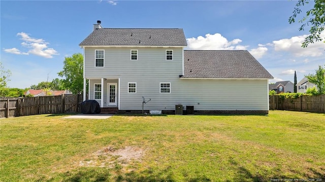 rear view of property with a fenced backyard, a patio, a lawn, and roof with shingles