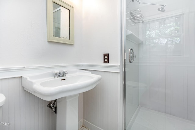 1324 Swallow Dr, Raleigh, NC 27606 - full bath with toilet, a shower stall, wainscoting, and a decorative wall