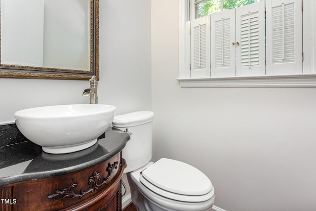 1324 Swallow Dr, Raleigh, NC 27606 - bathroom featuring toilet, vanity, and baseboards