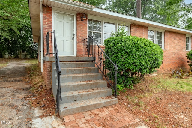 property entrance featuring brick siding