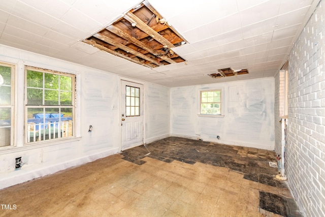 entryway featuring brick wall