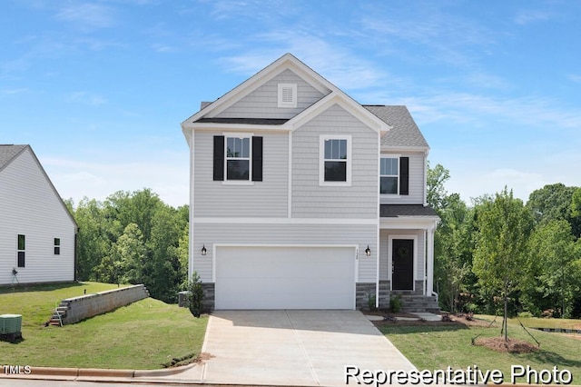 view of front of house with an attached garage, driveway, a front yard, and stone siding