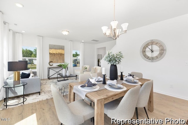 dining room featuring an inviting chandelier, visible vents, baseboards, light wood-style floors, and recessed lighting