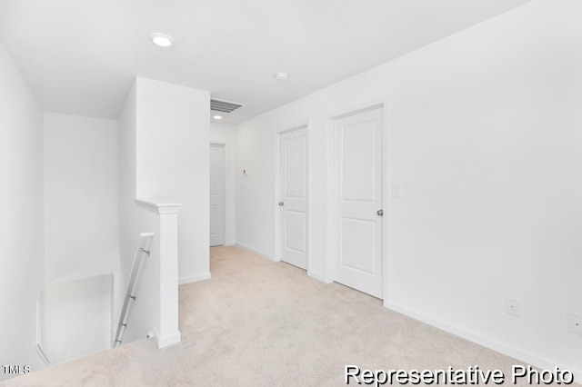 interior space featuring baseboards, recessed lighting, and visible vents