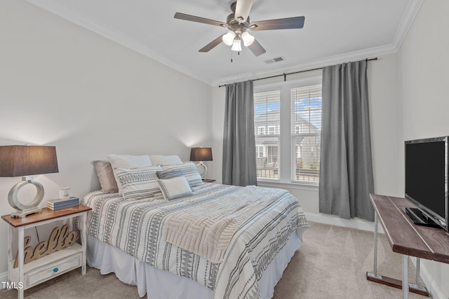 carpeted bedroom with ornamental molding, baseboards, and ceiling fan