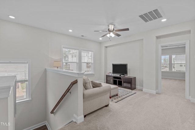 living room with light carpet, ceiling fan, recessed lighting, and baseboards