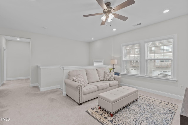 living room with a ceiling fan, light carpet, baseboards, and recessed lighting