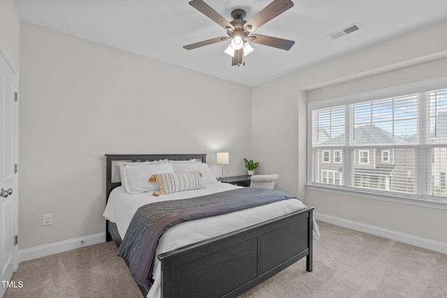 carpeted bedroom with baseboards and ceiling fan