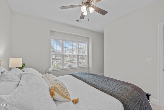 bedroom featuring baseboards, ceiling fan, and carpet