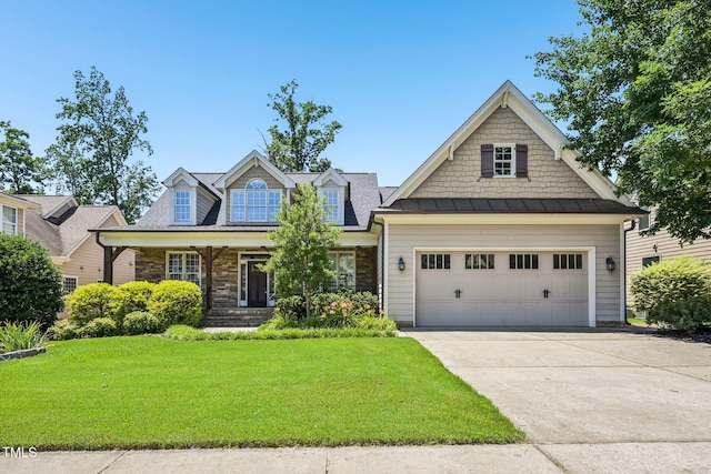 204 Plantation Dr, Youngsville, NC 27596 - view of front of property featuring a standing seam roof, a front yard, driveway, and stone siding
