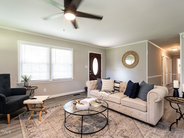 1612 Bethlehem Rd, Knightdale, NC 27545 - living area featuring wood finished floors, crown molding, ceiling fan, and baseboards