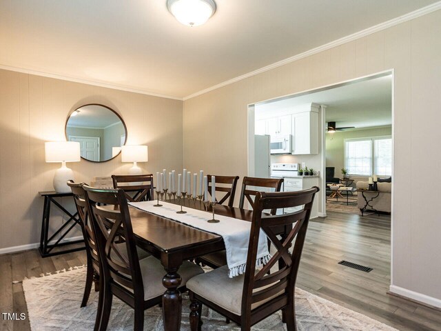 1612 Bethlehem Rd, Knightdale, NC 27545 - dining space with ornamental molding, wood finished floors, baseboards, and a ceiling fan