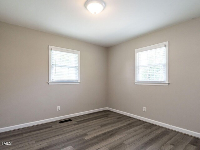 1612 Bethlehem Rd, Knightdale, NC 27545 - unfurnished room with healthy amount of natural light, dark wood finished floors, and baseboards