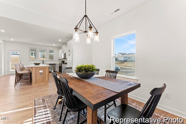 dining space with light wood-type flooring, recessed lighting, baseboards, and visible vents