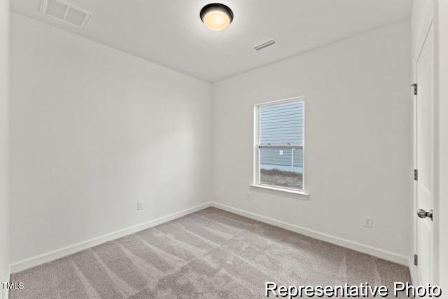 carpeted empty room with visible vents and baseboards