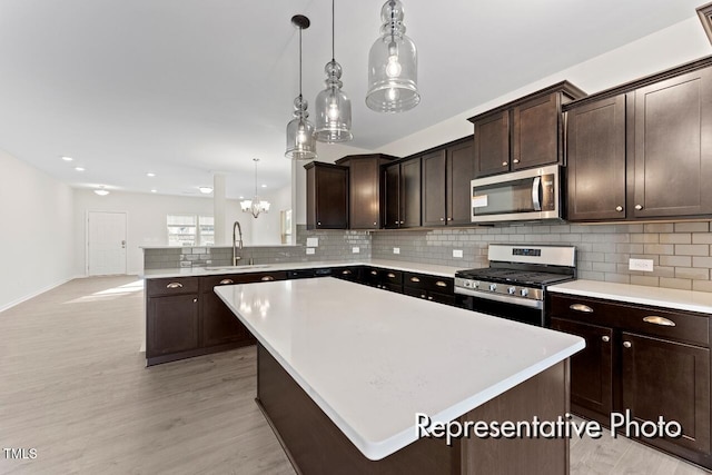 260 Curling Creek Dr Unit 235P, Clayton, NC 27527 - kitchen featuring stainless steel appliances, a sink, tasteful backsplash, dark brown cabinetry, and recessed lighting