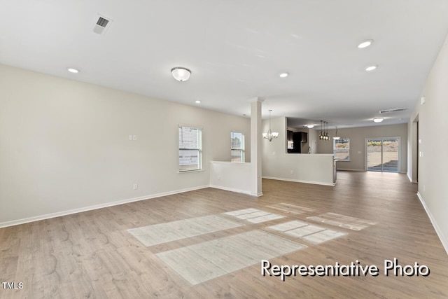 260 Curling Creek Dr Unit 235P, Clayton, NC 27527 - unfurnished living room featuring a chandelier, wood finished floors, baseboards, and recessed lighting
