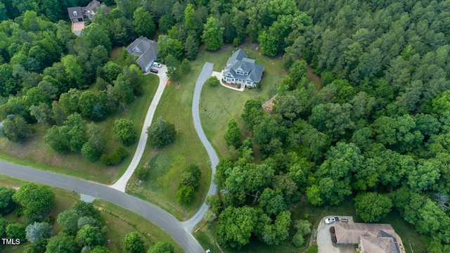 view of property location featuring a forest