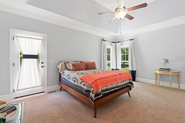 carpeted bedroom with ornamental molding, baseboards, access to exterior, a ceiling fan, and a raised ceiling