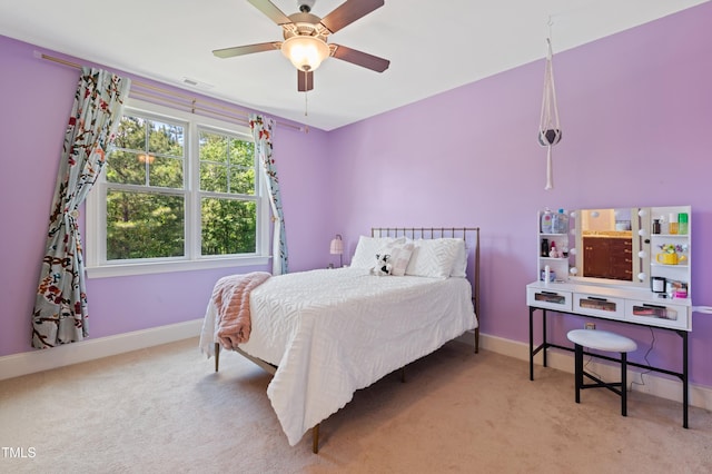 carpeted bedroom with baseboards and ceiling fan