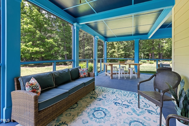 sunroom / solarium with outdoor lounge area and outdoor dining space