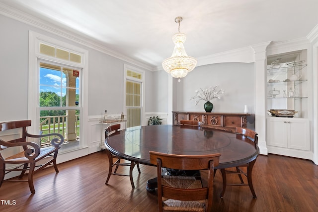 dining room featuring crown molding, dark wood-style floors, a chandelier, and wainscoting
