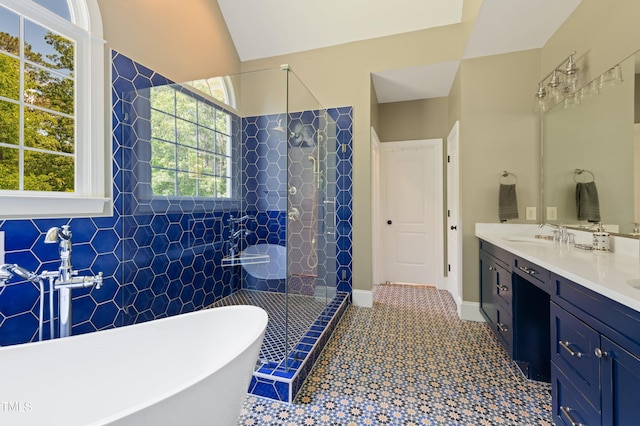 full bathroom featuring a shower stall, a freestanding tub, and double vanity
