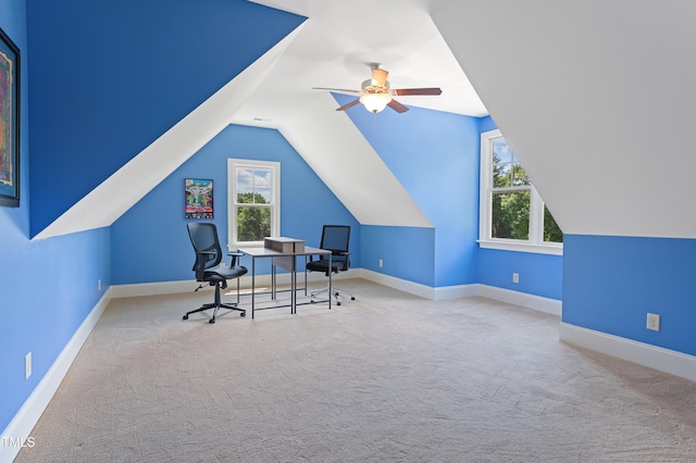 carpeted office space with ceiling fan, lofted ceiling, and baseboards