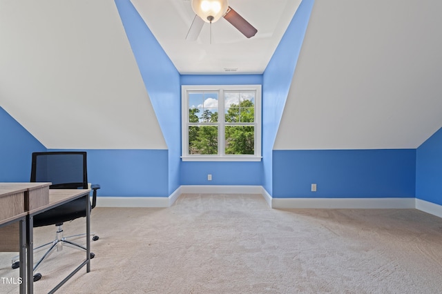 unfurnished office featuring baseboards, carpet flooring, ceiling fan, and vaulted ceiling