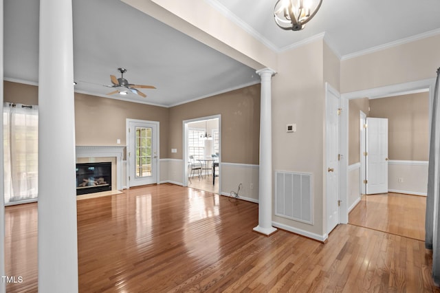 3653 Range Rd, Stem, NC 27581 - unfurnished living room with decorative columns, ceiling fan, wood finished floors, ornamental molding, and a fireplace with flush hearth