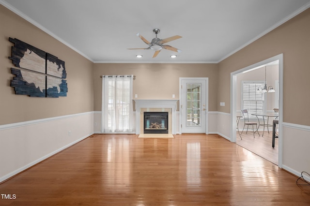 3653 Range Rd, Stem, NC 27581 - unfurnished living room featuring healthy amount of natural light, ceiling fan, light wood-style flooring, crown molding, and recessed lighting