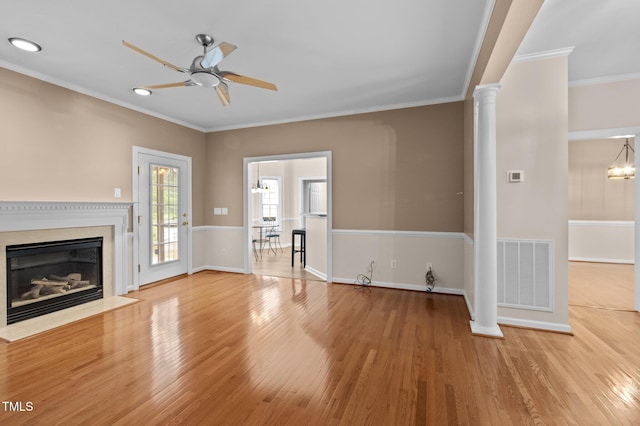 3653 Range Rd, Stem, NC 27581 - unfurnished living room with a ceiling fan, decorative columns, wood finished floors, a fireplace with flush hearth, and ornamental molding
