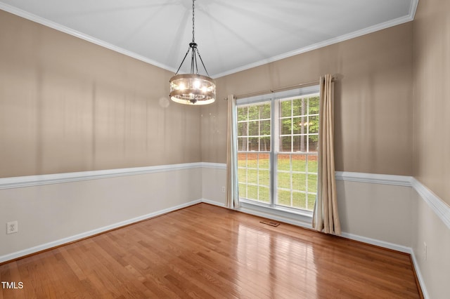 3653 Range Rd, Stem, NC 27581 - unfurnished dining area featuring wood finished floors, a chandelier, baseboards, and crown molding