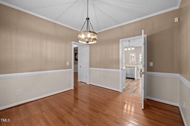 3653 Range Rd, Stem, NC 27581 - unfurnished dining area with a chandelier, wood finished floors, crown molding, and baseboards