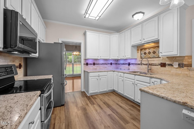 3653 Range Rd, Stem, NC 27581 - kitchen featuring stainless steel appliances, a sink, white cabinets, backsplash, and crown molding