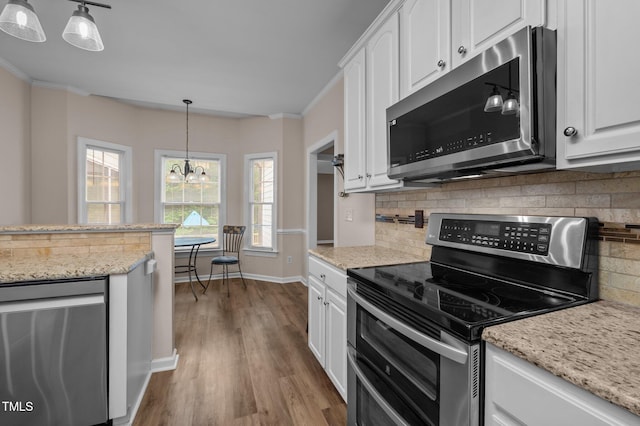 3653 Range Rd, Stem, NC 27581 - kitchen with stainless steel appliances, white cabinetry, dark wood-type flooring, a chandelier, and backsplash