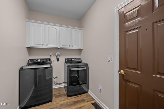 3653 Range Rd, Stem, NC 27581 - clothes washing area featuring independent washer and dryer, cabinet space, light wood-type flooring, and baseboards