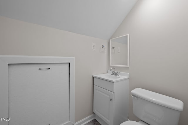 3653 Range Rd, Stem, NC 27581 - bathroom with lofted ceiling, vanity, and toilet