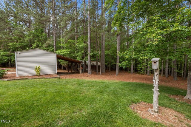 3653 Range Rd, Stem, NC 27581 - view of green lawn with an outbuilding, a storage shed, and a view of trees