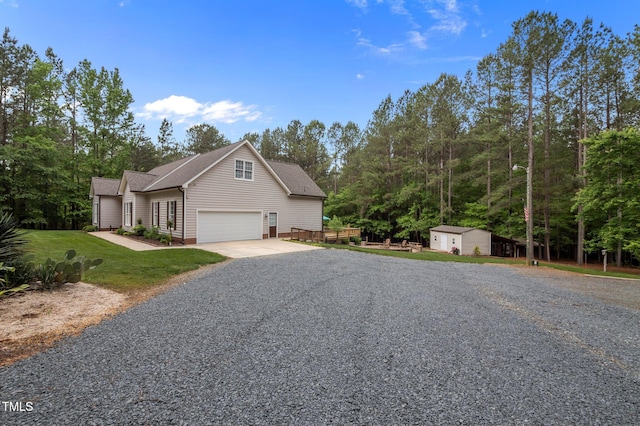 3653 Range Rd, Stem, NC 27581 - view of front facade featuring driveway, a shed, an outdoor structure, roof with shingles, and a front lawn
