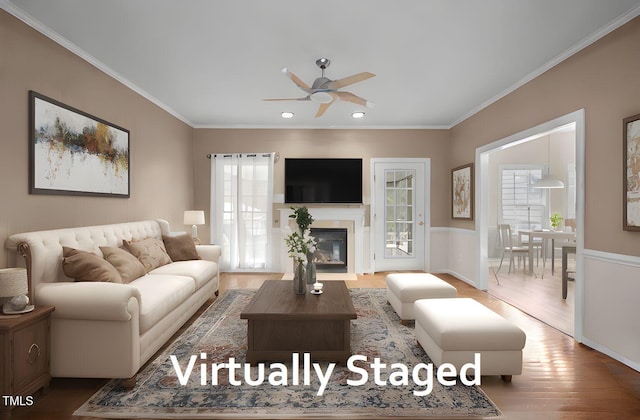 3653 Range Rd, Stem, NC 27581 - living area featuring ceiling fan, ornamental molding, wood finished floors, recessed lighting, and a glass covered fireplace