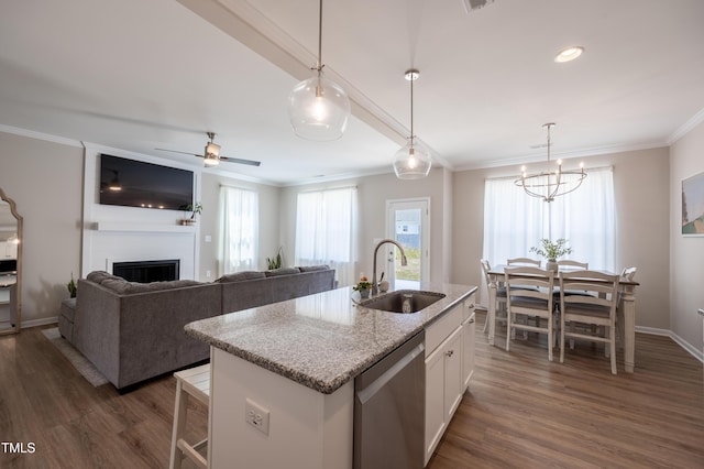4524 Sweet Williams Ln NW, Wilson, NC 27896 - kitchen with a sink, crown molding, dark wood-style floors, white cabinets, and stainless steel dishwasher